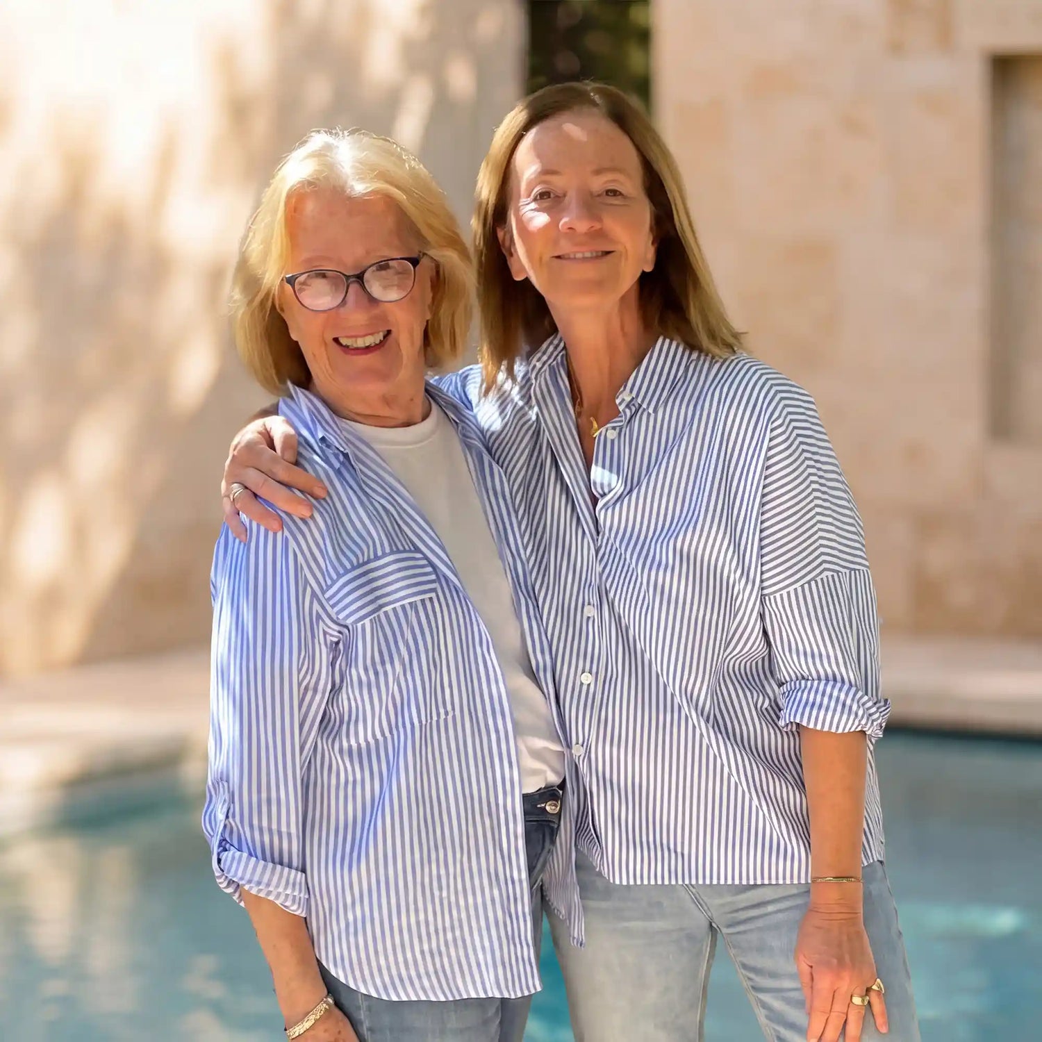 The two smiling Lovee founders outdoors, embodying the brand