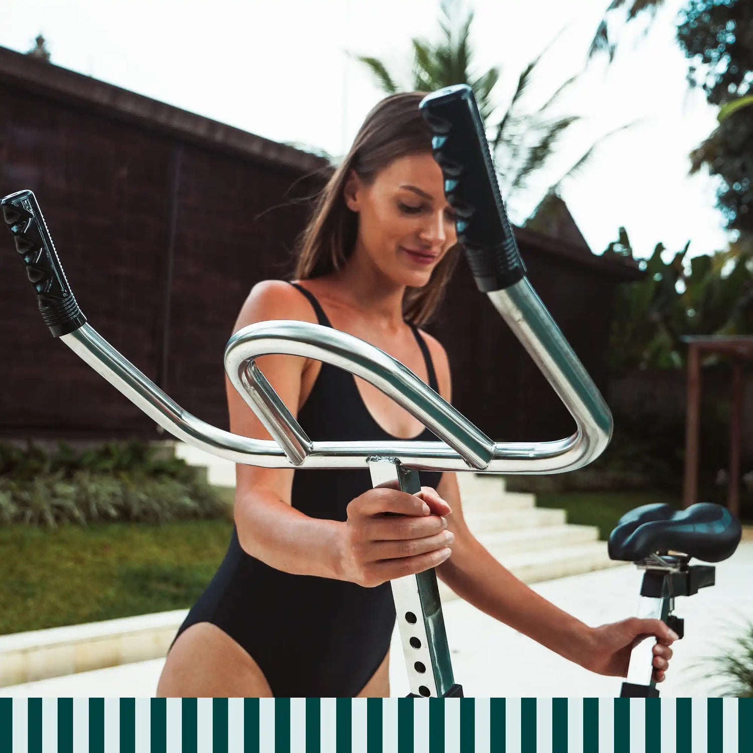 Woman using a Lovee Aquabike in a pool with ergonomic handlebars and a natural posture